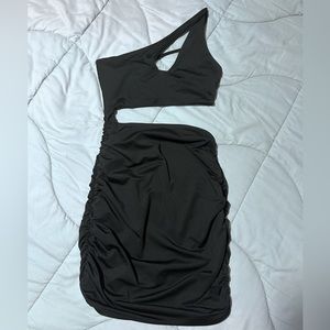 Black one shoulder strap cut out body contouring dress. Never worn. No tags.